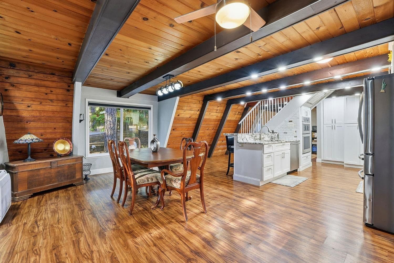The long dining table beneath the A-frame ceiling